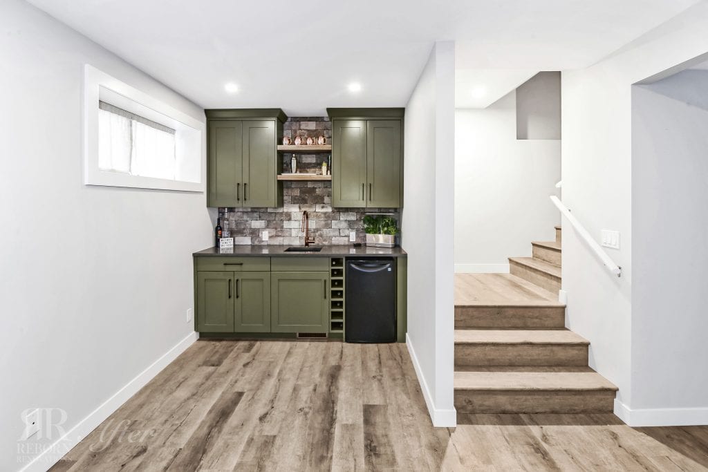 A small kitchenette with green cabinets in an Altadore basement renovation.