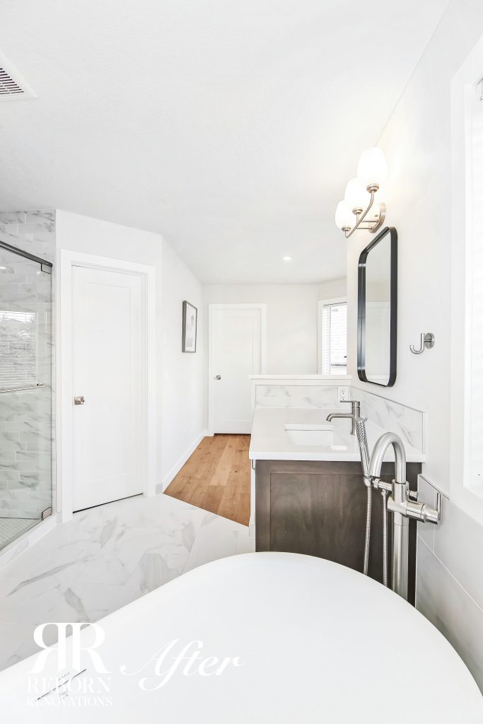 Photos of new design bathroom, white painted walls, combined with tile and wooden floor, frameless shower room, dark wooden cabinets, square-round mirror in Calgary, AB, Canada
