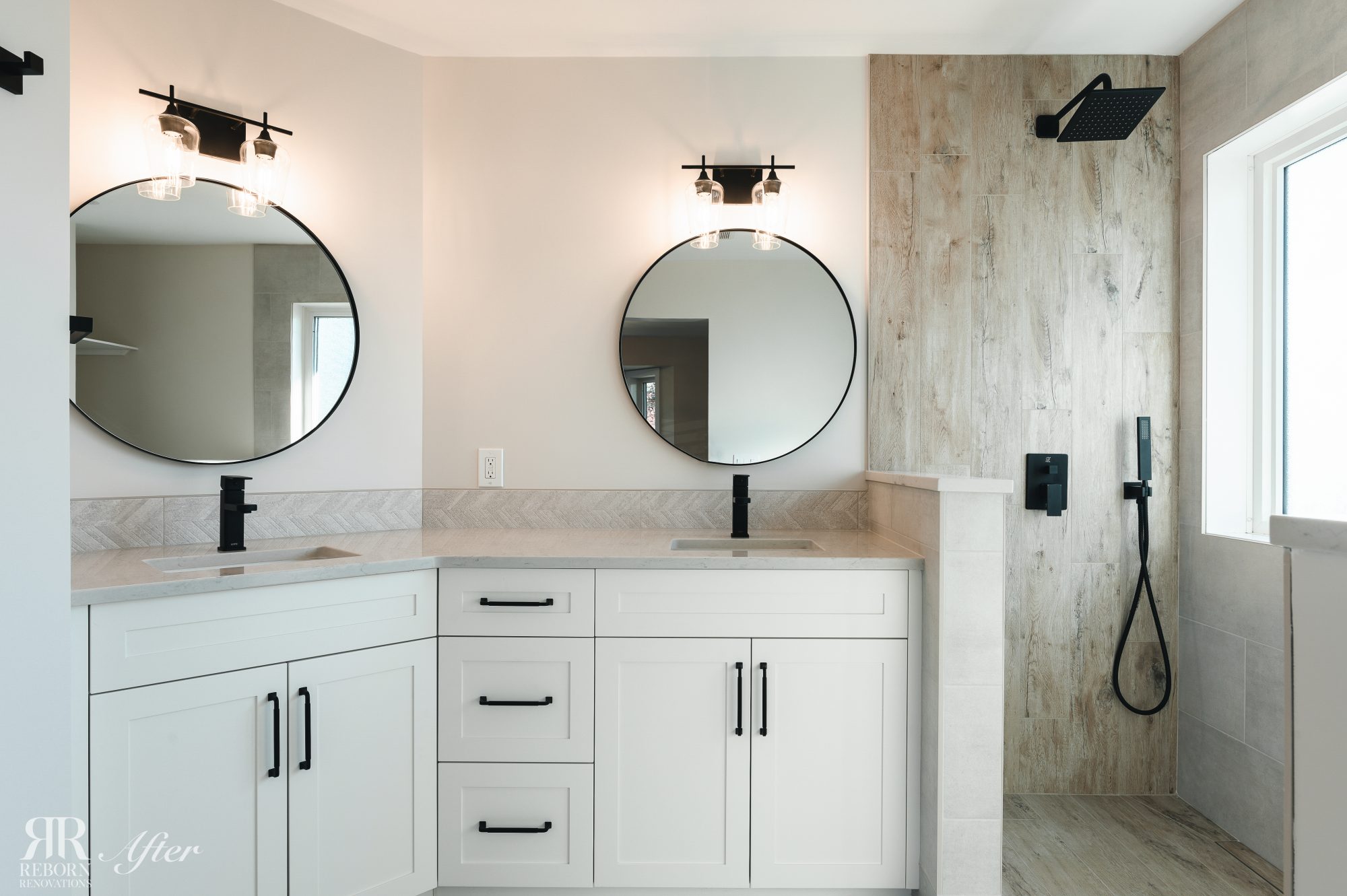 Primary bathroom featuring dual vanity and mirrors in Okotoks