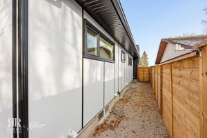 A small backyard with a wooden fence and white siding in Wildwood.